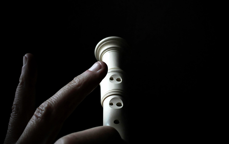 Fingers playing a recorder